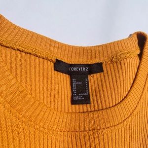 Mustard yellow short sleeve shirt.